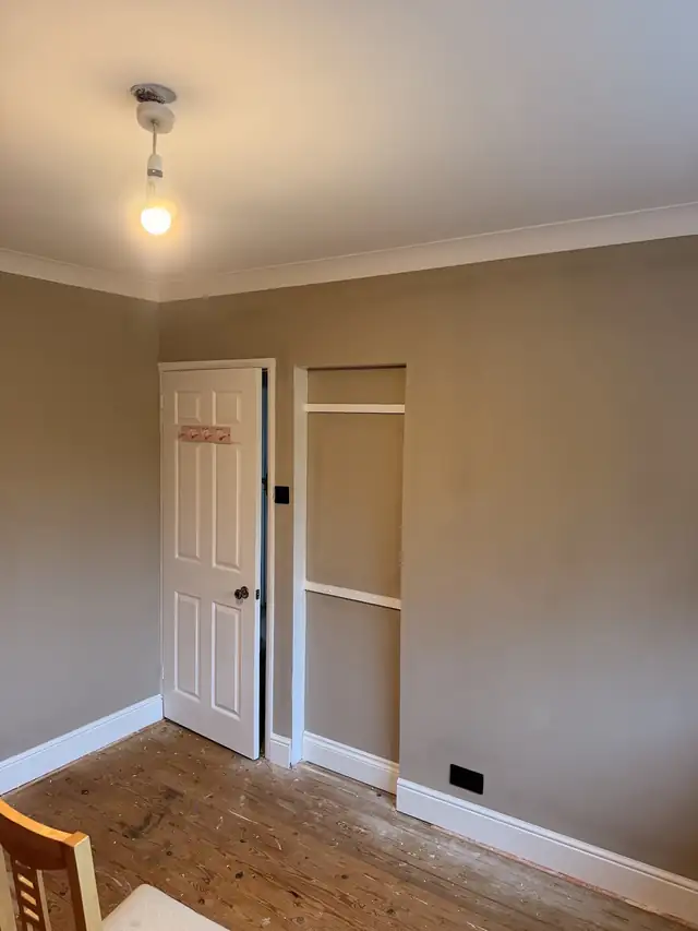 Room with smooth stone coloured walls, white coving and white skirting